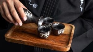 Sake class participant trying to pour sake WSA Bangkok