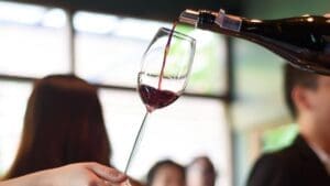 WSA Bangkok HORECA program trainer demonstrating wine pouring technique